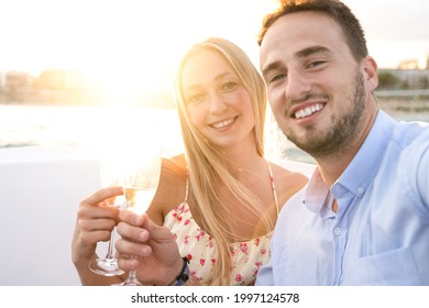 Young Couple Doing Selfie Drinking Champagne In Vip Luxury Sail Boat During Summer Vacation - Happy People Rich Lifestyle Concept - Focus On Girl Face