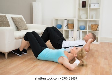 Young Couple Doing Workout Together At Home