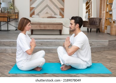 Young Couple Doing Yoga Together At Home