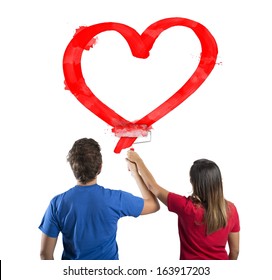 Young Couple Drawing A Big Red Heart