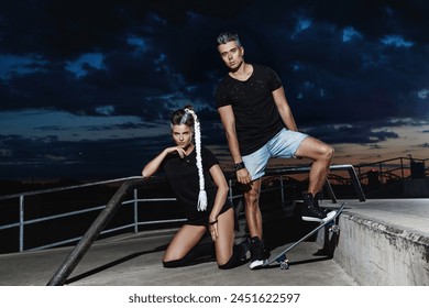 Young couple dressed in trendy urban-style clothes poses in a skatepark. - Powered by Shutterstock