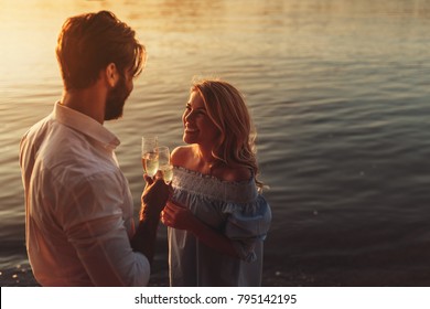 Young Couple Drinking Champagne Outdoors