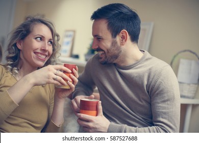 Young Couple Drinking Coffee At Home.