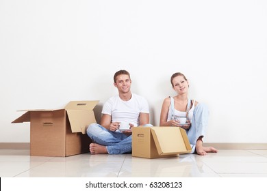 Young couple drinking coffee on the floor - Powered by Shutterstock