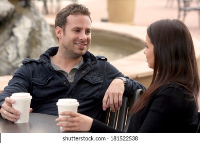 Young Couple Drinking Coffee Outside