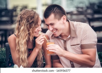 young couple with drinks in cafe outdoor, summer day - Powered by Shutterstock