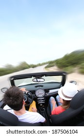 Young Couple Driving Convertible Car