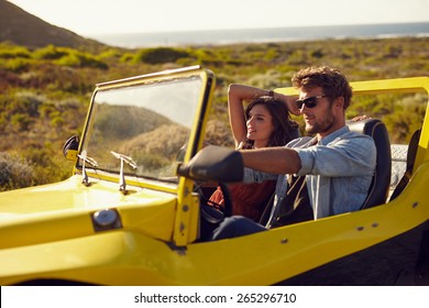 Young couple driving their car on a roadtrip. Handsome young man with his girlfriend on a holiday. Couple on a long drive. - Powered by Shutterstock