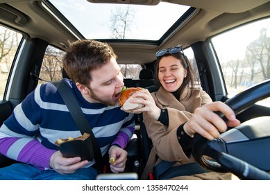 Young Couple Eating Fast Food In Car. Modern Rhythm Lifestyle