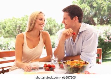 Young Couple Eating Outdoors