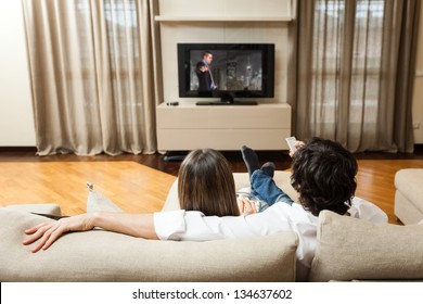 Young Couple Eating Popcorn While Watching A Movie