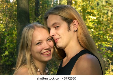 Young couple embracing at the autumn forest