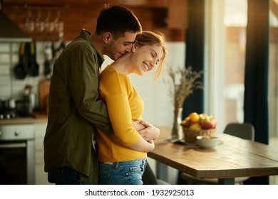 Young couple embracing and having fun together at home.  - Powered by Shutterstock