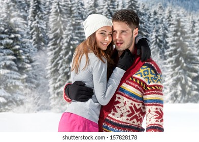 Young Couple Embracing In Winter Park