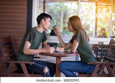 Young Couple Enjoying Coffee And Cake In Cafe,Couple Dating Dessert Restaurant Eating Concept