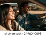 Young couple enjoying the freedom on a Car Trip over a country offroad