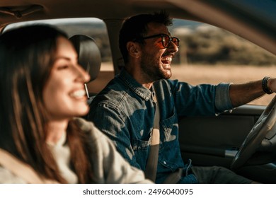 Young couple enjoying the freedom on a Car Trip over a country offroad - Powered by Shutterstock