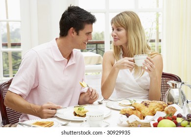 Young Couple Enjoying Hotel Breakfast