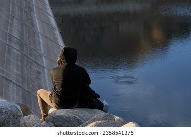Young Couple Enjoying Lakeside View at Sunset by the Dam - Powered by Shutterstock
