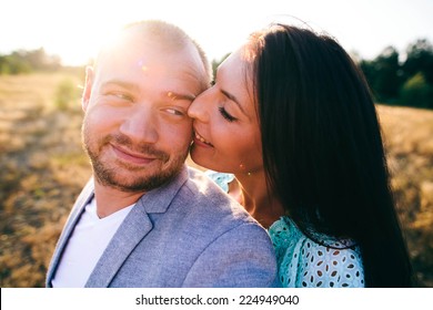 Young Couple Enjoying Love On Summer Meadow