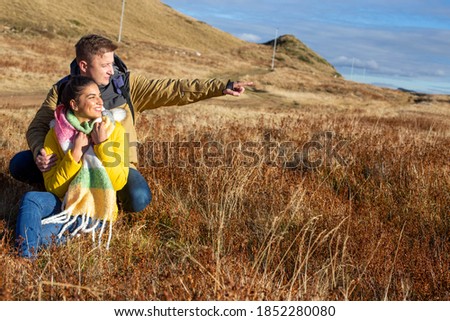 Similar – Image, Stock Photo Young couple taking a walk near the coast