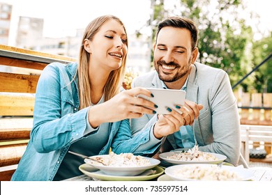 Young Couple Enjoying Restaurant And Eating Pasta.