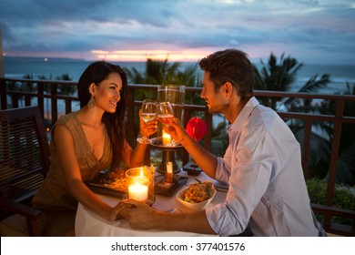 young couple enjoying a romantic dinner by candlelight, outdoor