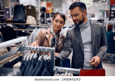 Young couple enjoying in shopping clothes at the store.  - Powered by Shutterstock