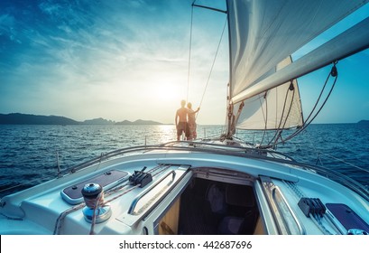 Young couple enjoying sunset on the yacht in Andaman sea