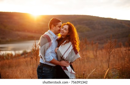 Young couple enjoying the sunset. Romantic and love. Happy smiling lovely couple. Adventurous couple walking in a field and warm sunset. Couple in love kissing laughing having fun.
 - Shutterstock ID 756391342