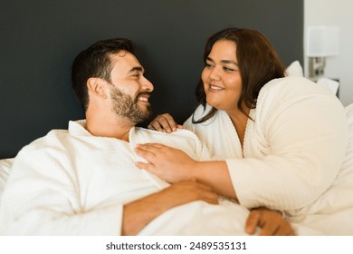 Young couple is enjoying their vacation and spending some quality time together while relaxing in their hotel room - Powered by Shutterstock