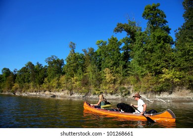 Young couple enjoying a trip in a canoe - Powered by Shutterstock