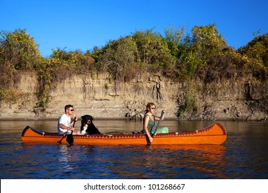 Young couple enjoying a trip in a canoe - Powered by Shutterstock