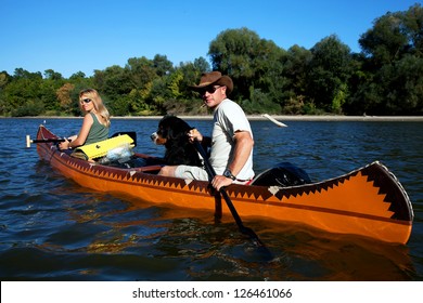 Young Couple Enjoying A Trip In A Canoe