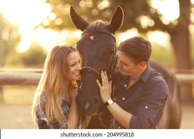 Young couple enjoys spending time with horses