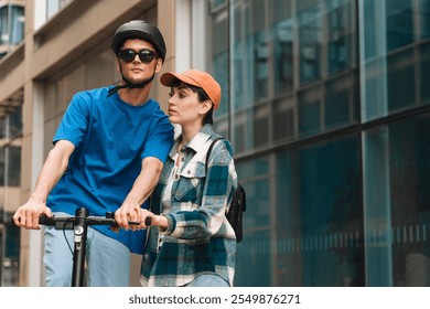 Young couple enjoys a sunny day riding an electric scooter in an urban environment together - Powered by Shutterstock