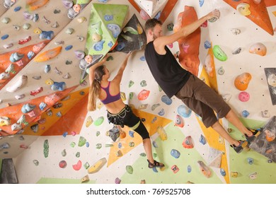 Young couple exercising in climbing gym - Powered by Shutterstock