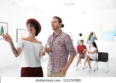 Young Couple At Exhibition In Art Gallery