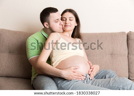 Similar – Pregnant woman embraced by her husband