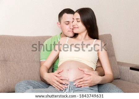 Similar – Pregnant woman embraced by her husband