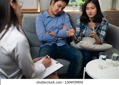 Young couple family relation problem concept : Young Asian couple received a treatment from psychologist at clinic. Young Asian couple have a relation problem.
