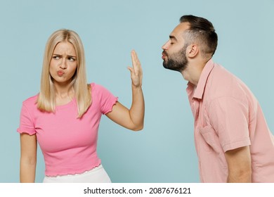 Young couple family two friends in casual clothes man try want kiss woman but she doing stop palm gesture and does not want it together isolated on pastel plain light blue background studio portrait - Powered by Shutterstock