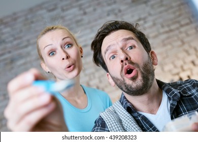 Young Couple Feeding Baby. Photographed From Baby's Point Of View.