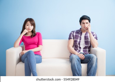 Young Couple Feel Bad And Look Somewhere Sit On Sofa At Home