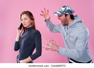 Young couple fighting and screaming at each other, can't resolve an issue and getting into a conflict, man jealous at his girlfriend