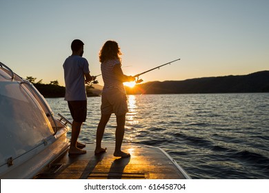 A Young Couple Fishing at Sunset