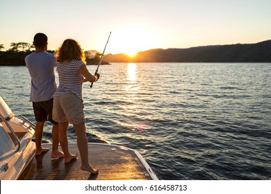 A Young Couple Fishing at Sunset - Powered by Shutterstock