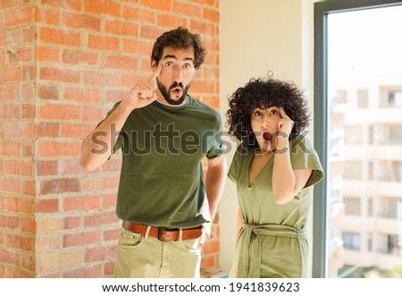 young couple gesturing. new home concept