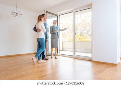 Young Couple Getting Tour Through Apartment They Consider Renting Or Purchasing 