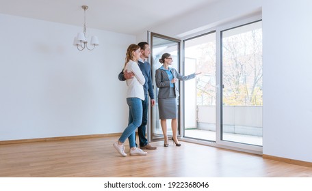 Young Couple Getting Tour Through Apartment They Consider Renting Or Purchasing